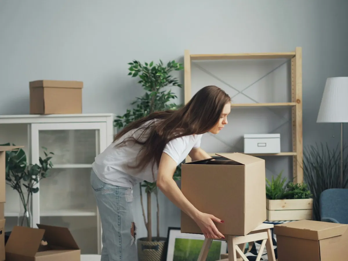 Person packing cardboard boxes ready for storage collection