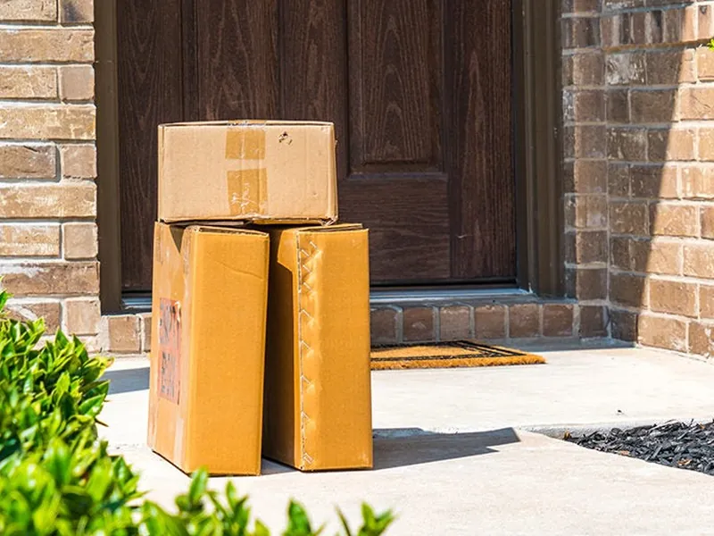 Cardboard boxes delivered back to a front door